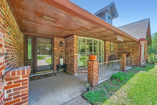 a view of a porch with wooden floor and fence
