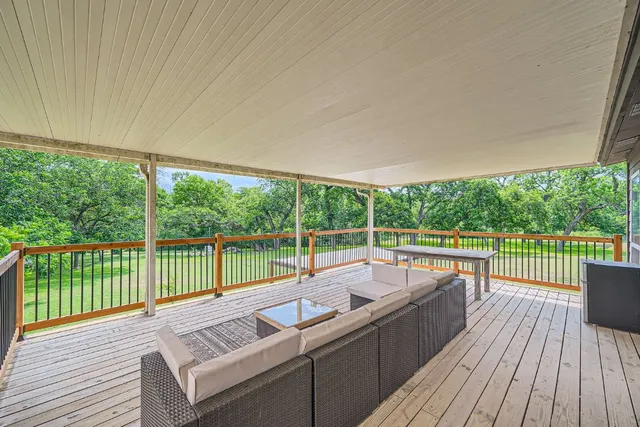 a view of balcony with wooden floor and outdoor seating