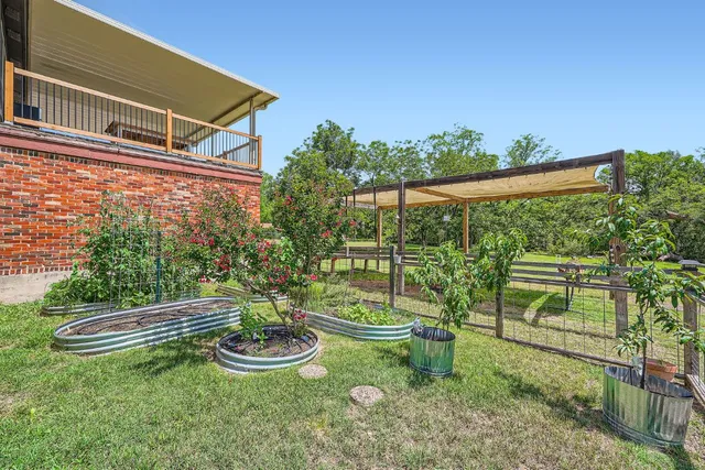 a view of a chair and table in backyard