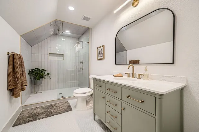 a bathroom with a sink a toilet and a mirror