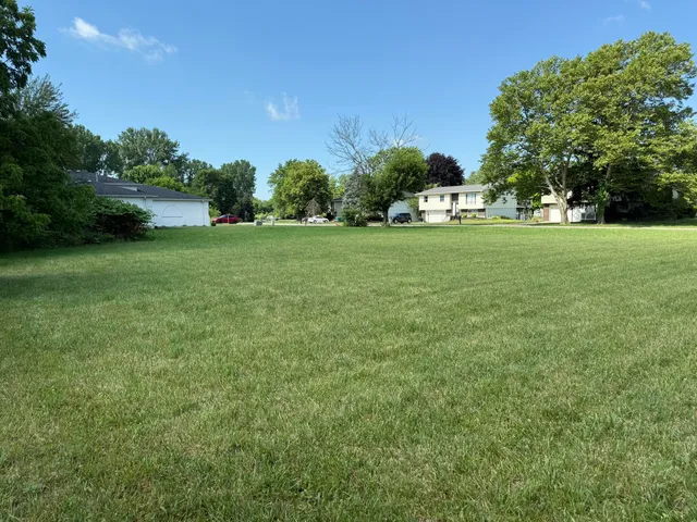 a view of house with garden space and trees