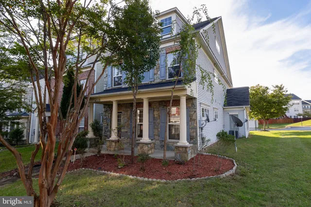a view of a house with backyard porch and sitting area
