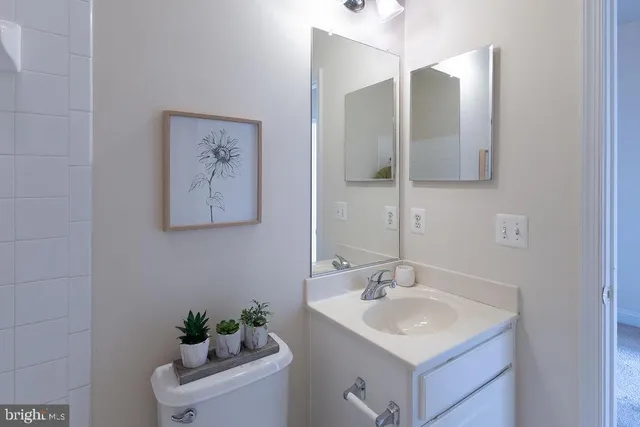 a bathroom with a sink vanity and a mirror