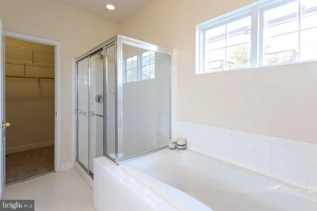 a bathroom with a bathtub and a shower