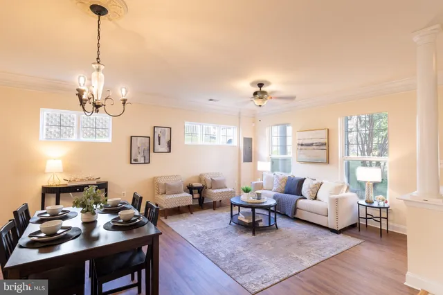 a living room with furniture and a chandelier