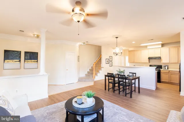a view of a a dining room with furniture wooden floor and chandelier