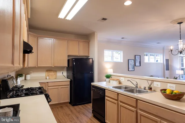 a kitchen with a sink appliances and cabinets