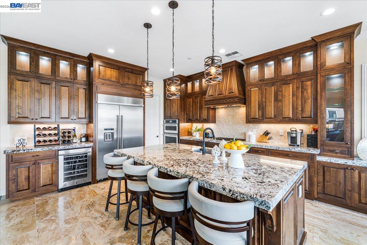 205 Zinnia Court San Ramon, CA 94582 - Photo 15 of 40 a kitchen with a dining table chairs and white cabinets