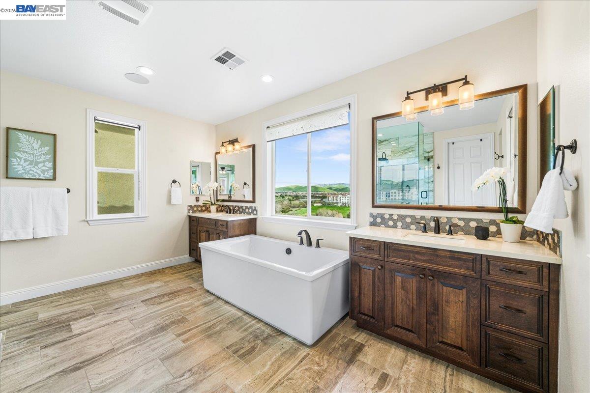 205 Zinnia Court San Ramon, CA 94582 - Photo 24 of 40 a spacious bathroom with a double vanity sink a mirror and a bathtub