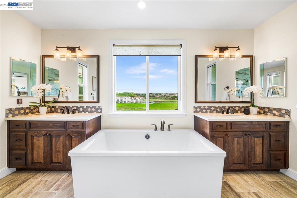 205 Zinnia Court San Ramon, CA 94582 - Photo 25 of 40 a spacious bathroom with a granite countertop sink and a large mirror