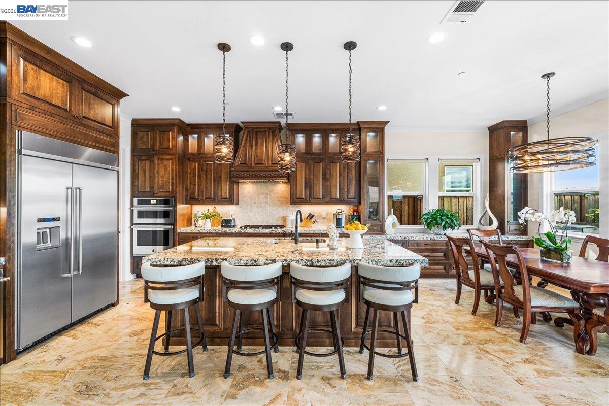 205 Zinnia Court San Ramon, CA 94582 - Photo 9 of 40 a kitchen with a large window and chairs