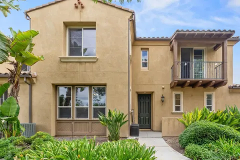 a front view of a house with potted plants