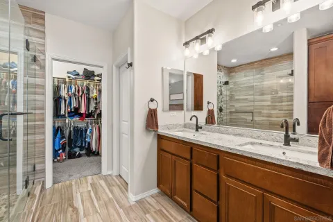 a en suite bathroom with a sink a mirror and a shower