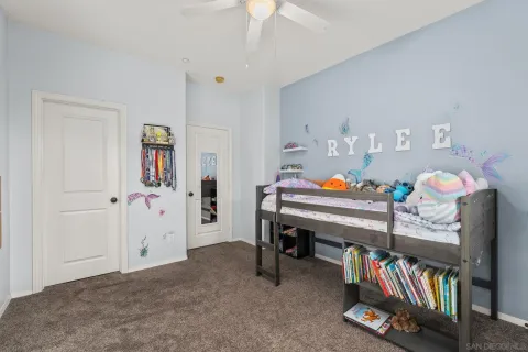 a bedroom with furniture and a book shelf