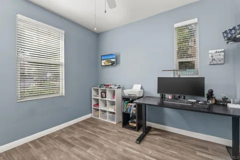 a view of a workspace with furniture and a window