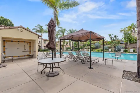 a view of a patio with a table and chairs under an umbrella