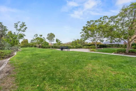 a view of a green field with wooden fence