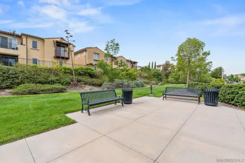 a park view with a bench sitting in back yard