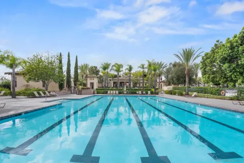 a view of swimming pool with outdoor seating and yard in the back