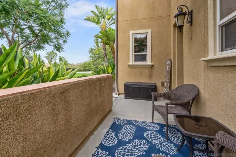 a balcony with table and chairs