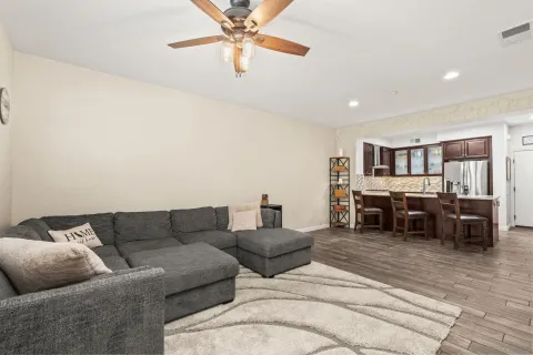 a living room with furniture and wooden floor