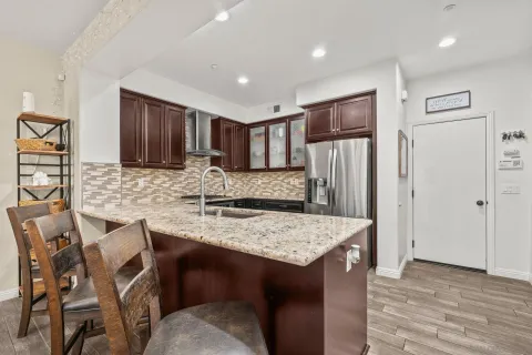 a kitchen with kitchen island a refrigerator stove and center island