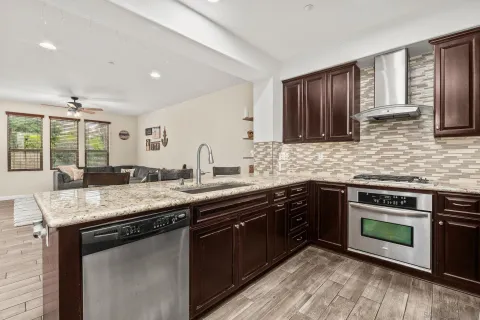 a kitchen with a sink stove and cabinets