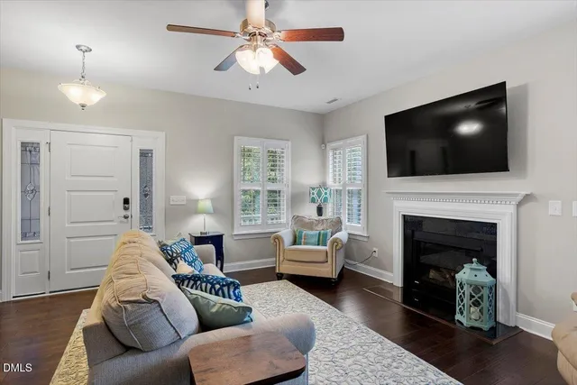 a living room with furniture a fireplace and a flat screen tv