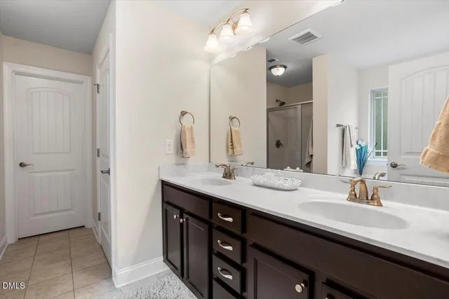 a bedroom with a large bed and flat tv screen on dresser