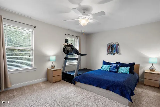 a bed sitting in a bedroom next to a window