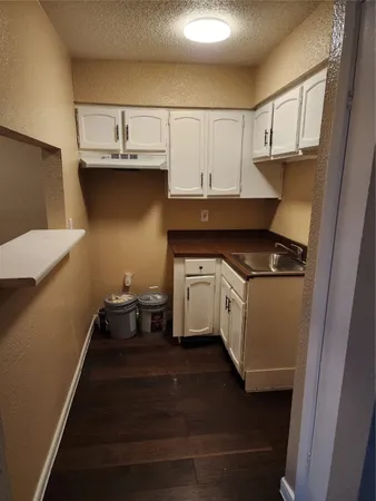 a kitchen with a sink a stove and cabinets
