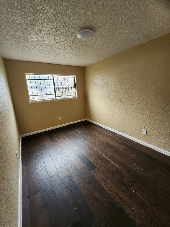 4311 Yellowstone Boulevard, Unit 7 Houston, TX 77021 - Photo 4 of 7 an empty room with wooden floor and windows