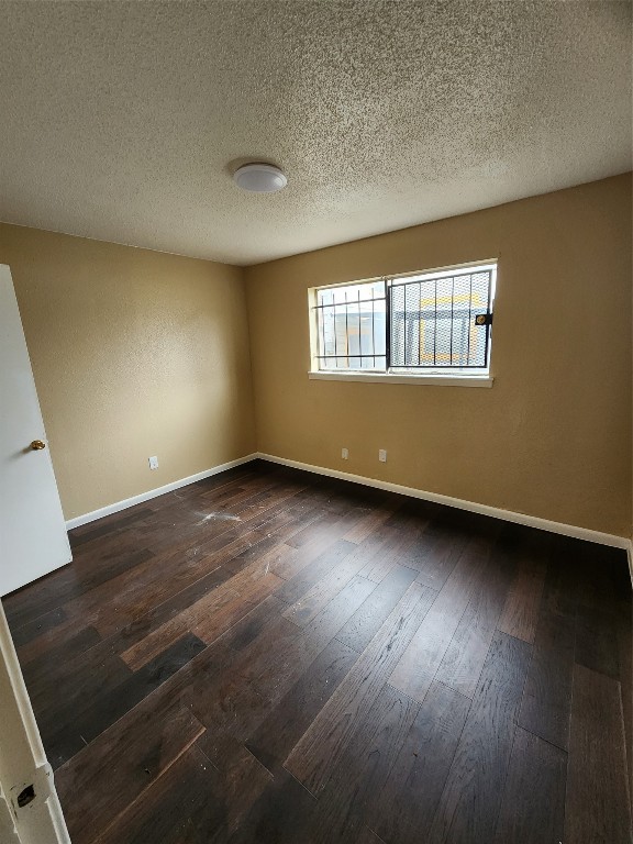 4311 Yellowstone Boulevard, Unit 7 Houston, TX 77021 - Photo 5 of 7 an empty room with wooden floor and windows