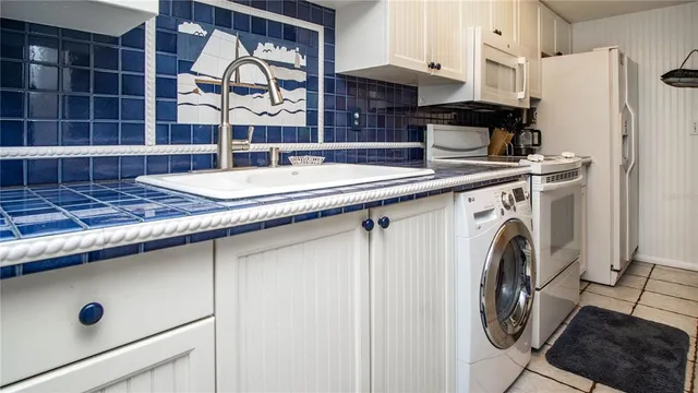 a kitchen with a sink a stove and cabinets