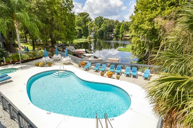 a front view of building with lot of cars and trees