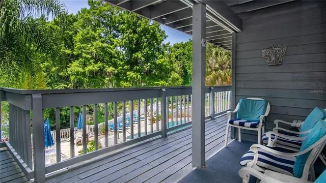 a balcony view with two chairs and a potted plant
