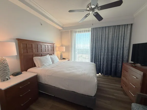 a bedroom with a bed and a flat screen tv