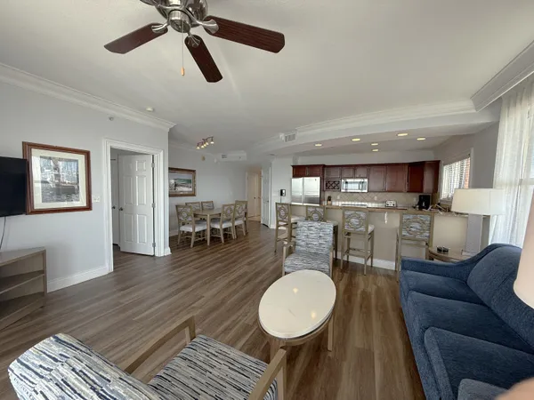 a living room with furniture a wooden floor and a chandelier
