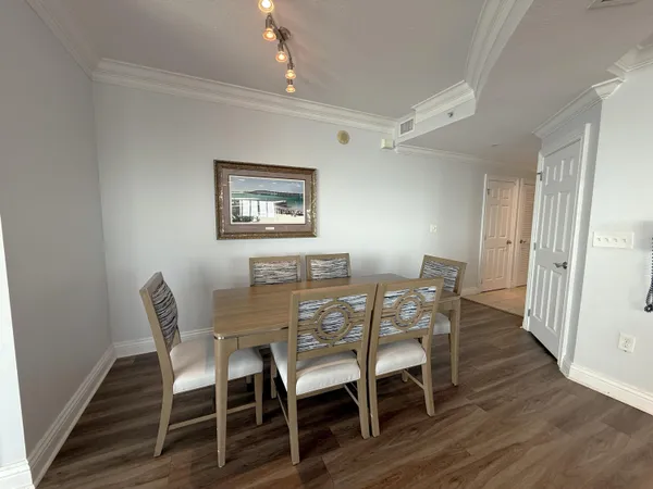 a view of a dining room with furniture and wooden floor