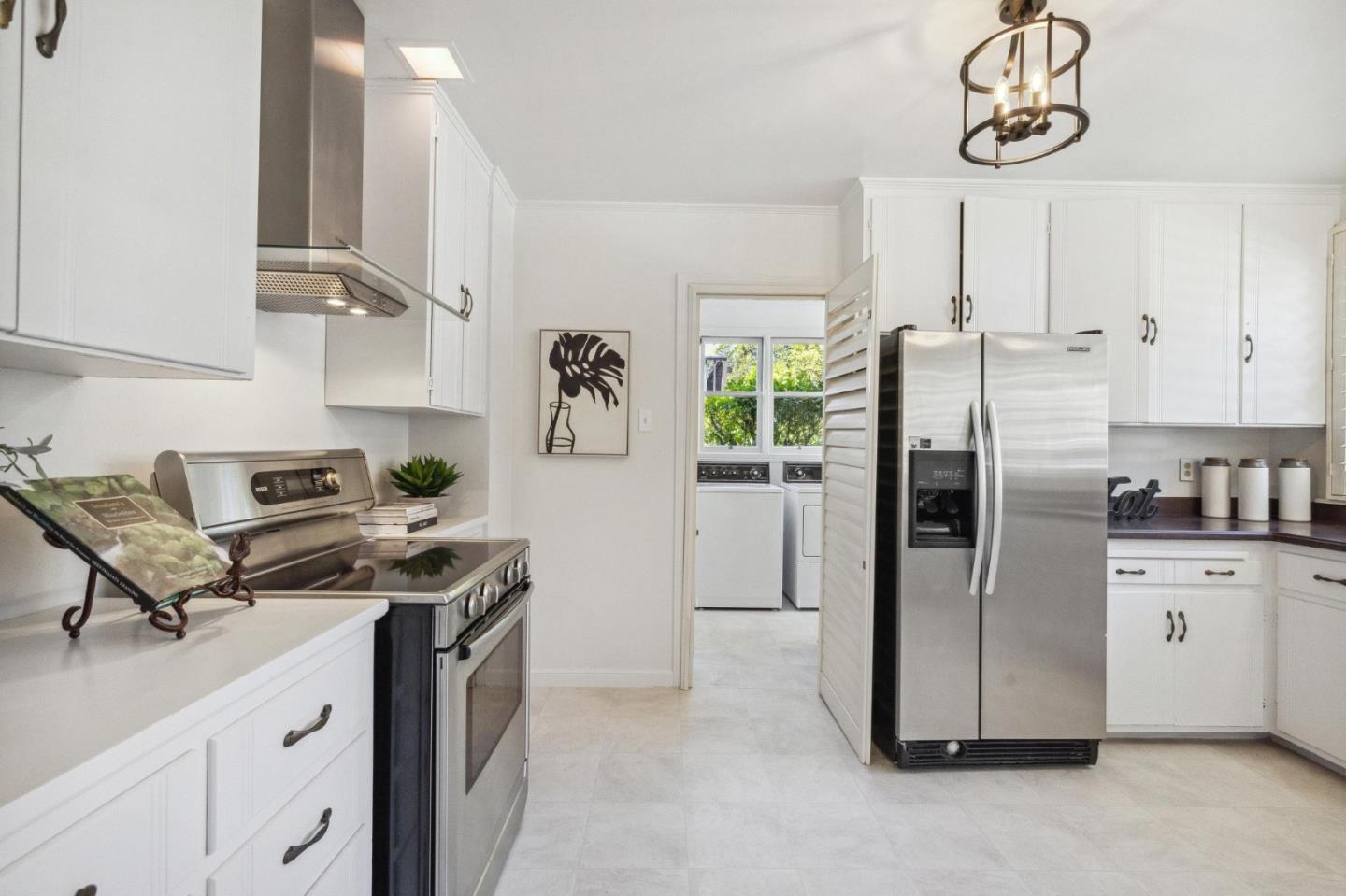 1820 Broadway Burlingame, CA 94010 - Photo 20 of 55 a kitchen with stainless steel appliances granite countertop a refrigerator a stove a sink and a counter space