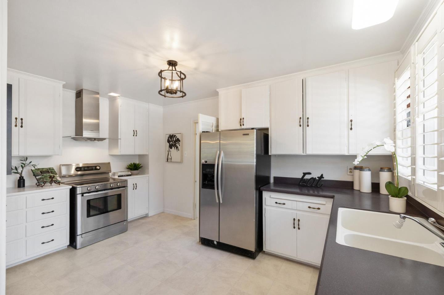 1820 Broadway Burlingame, CA 94010 - Photo 25 of 55 a kitchen with stainless steel appliances granite countertop a sink stove and refrigerator