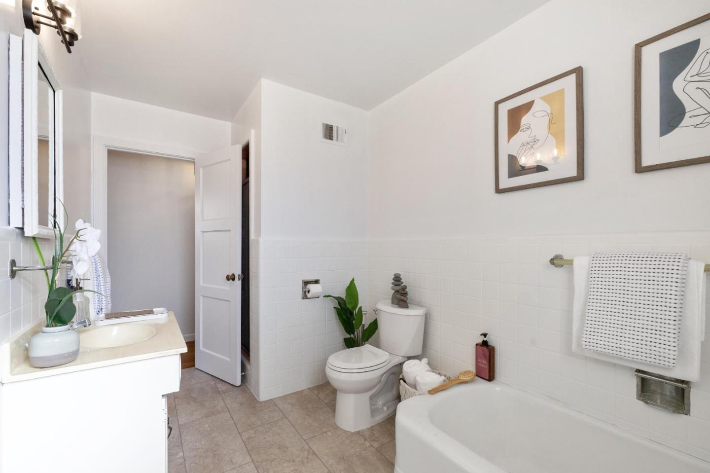 1820 Broadway Burlingame, CA 94010 - Photo 44 of 55 a bathroom with a toilet sink and mirror