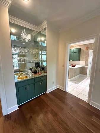 a kitchen with a wooden floor and a large window