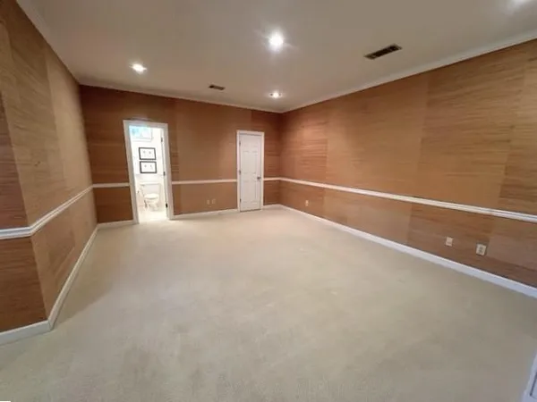 a view of an empty room with a fireplace and a window