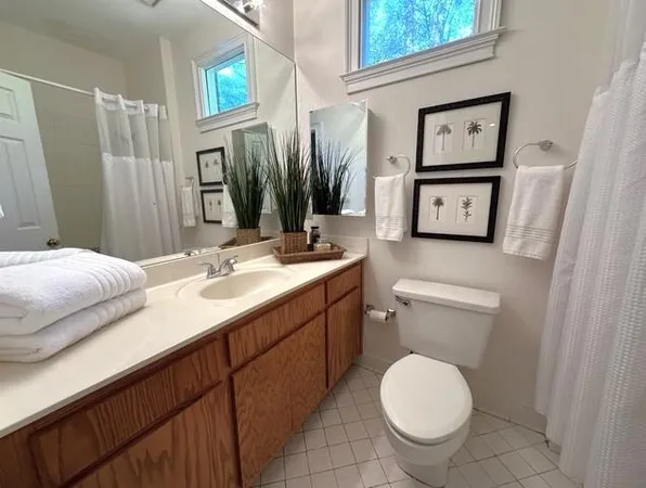 a view of an empty room with a cabinet and mirrors
