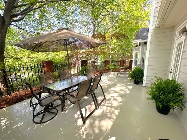 a view of a patio with chairs and potted plants