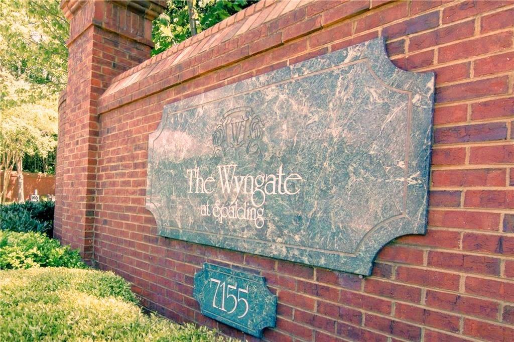 7155 Roswell Road, Unit 40 Sandy Springs, GA 30328 - Photo 38 of 42 a brick building with a street sign on it