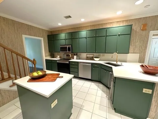 a kitchen with a sink cabinets and window
