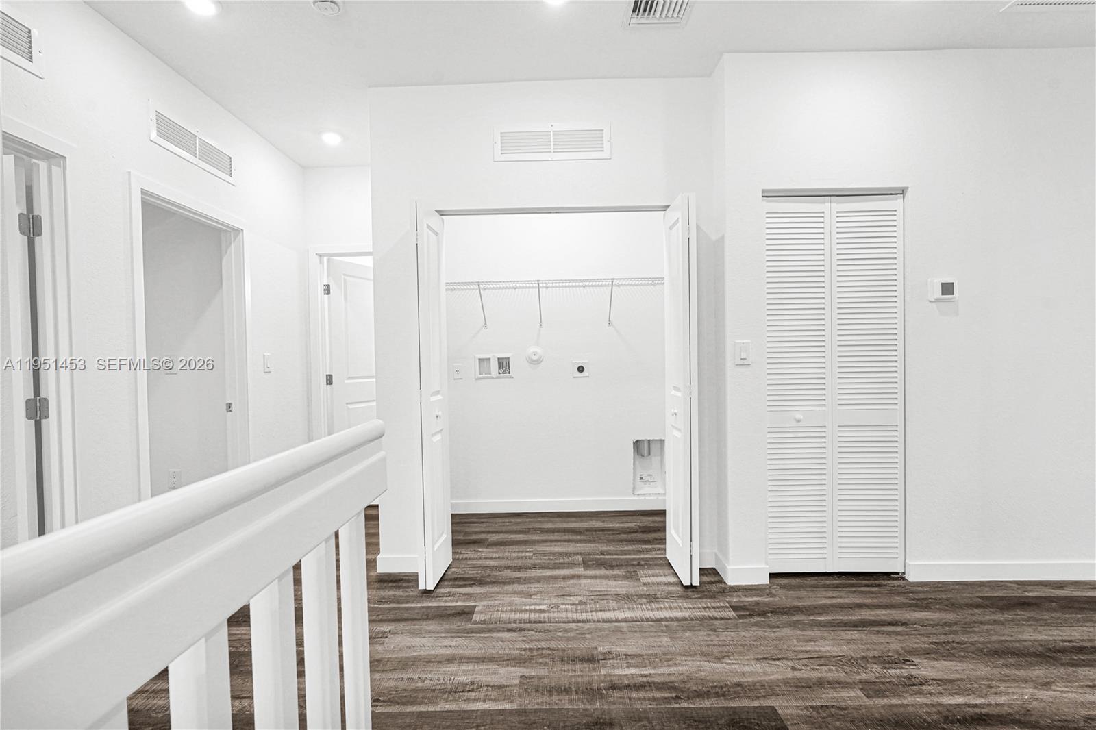 22431 Southwest 125th Avenue, Unit 19B Homestead, FL 33033 - Photo 17 of 40 a view of a hallway with wooden floor and staircase