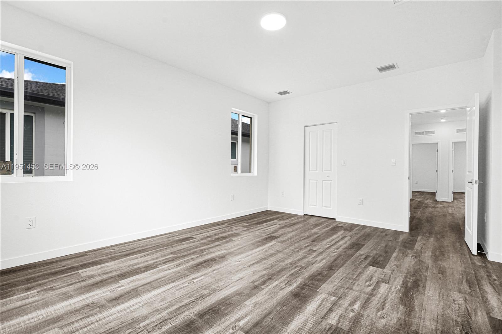 22431 Southwest 125th Avenue, Unit 19B Homestead, FL 33033 - Photo 34 of 40 a view of empty room with wooden floor and fan